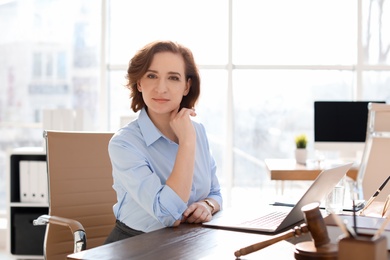 Female lawyer working at table in office