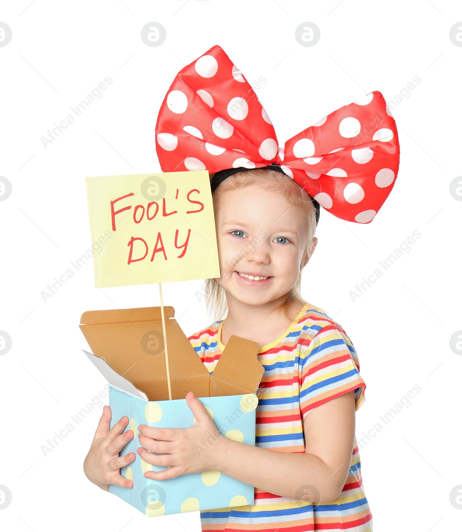 Photo of Little girl with large bow and April fool's day sign on white background