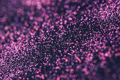 Photo of Pink glitter with bokeh effect on dark background