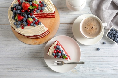 Photo of Delicious homemade red velvet cake served with coffee on table, flat lay