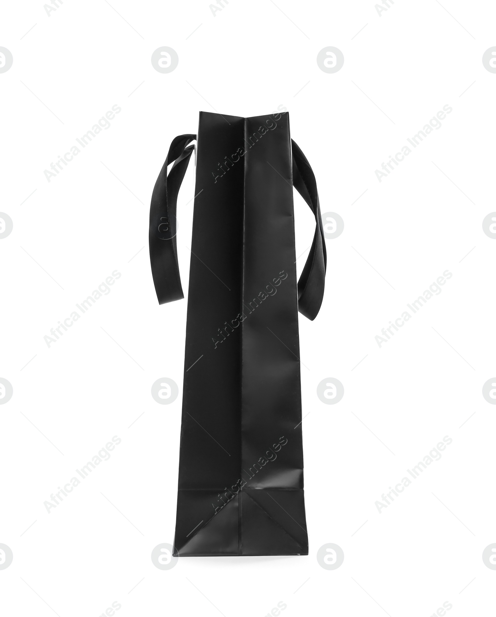 Photo of Paper shopping bag with ribbon handles on white background