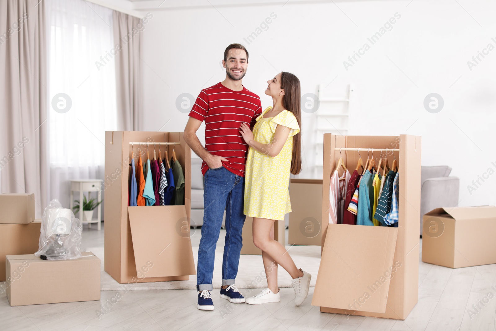 Photo of Young couple near wardrobe boxes at home