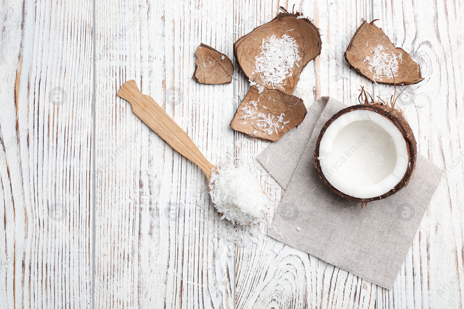 Photo of Composition with fresh coconut flakes on wooden background, top view