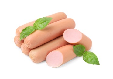 Photo of Whole and cut delicious boiled sausages with basil on white background