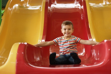 Cute little child playing at indoor amusement park