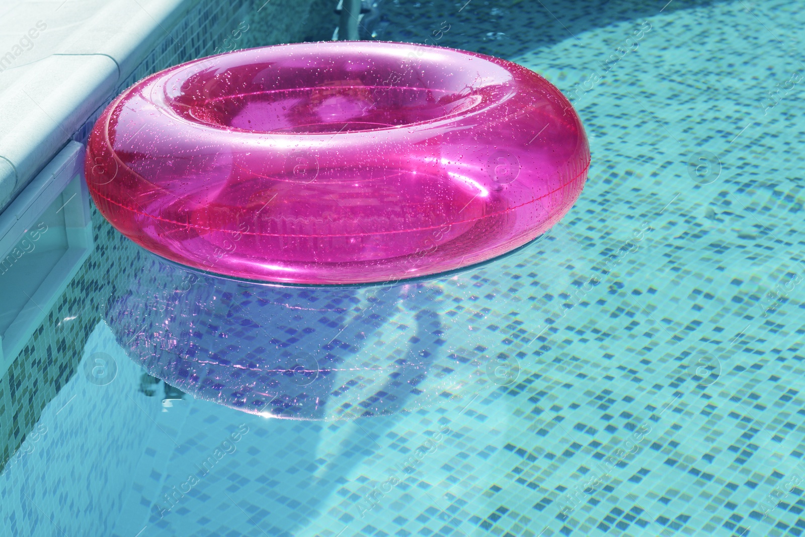 Photo of Inflatable ring floating on water in swimming pool