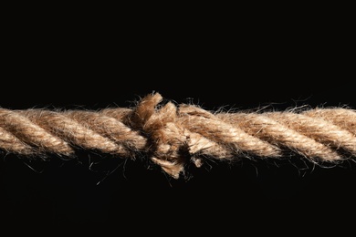 Photo of Rupture of cotton rope on black background