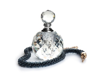 Photo of Glass bottle of perfume and luxury jewellery isolated on white