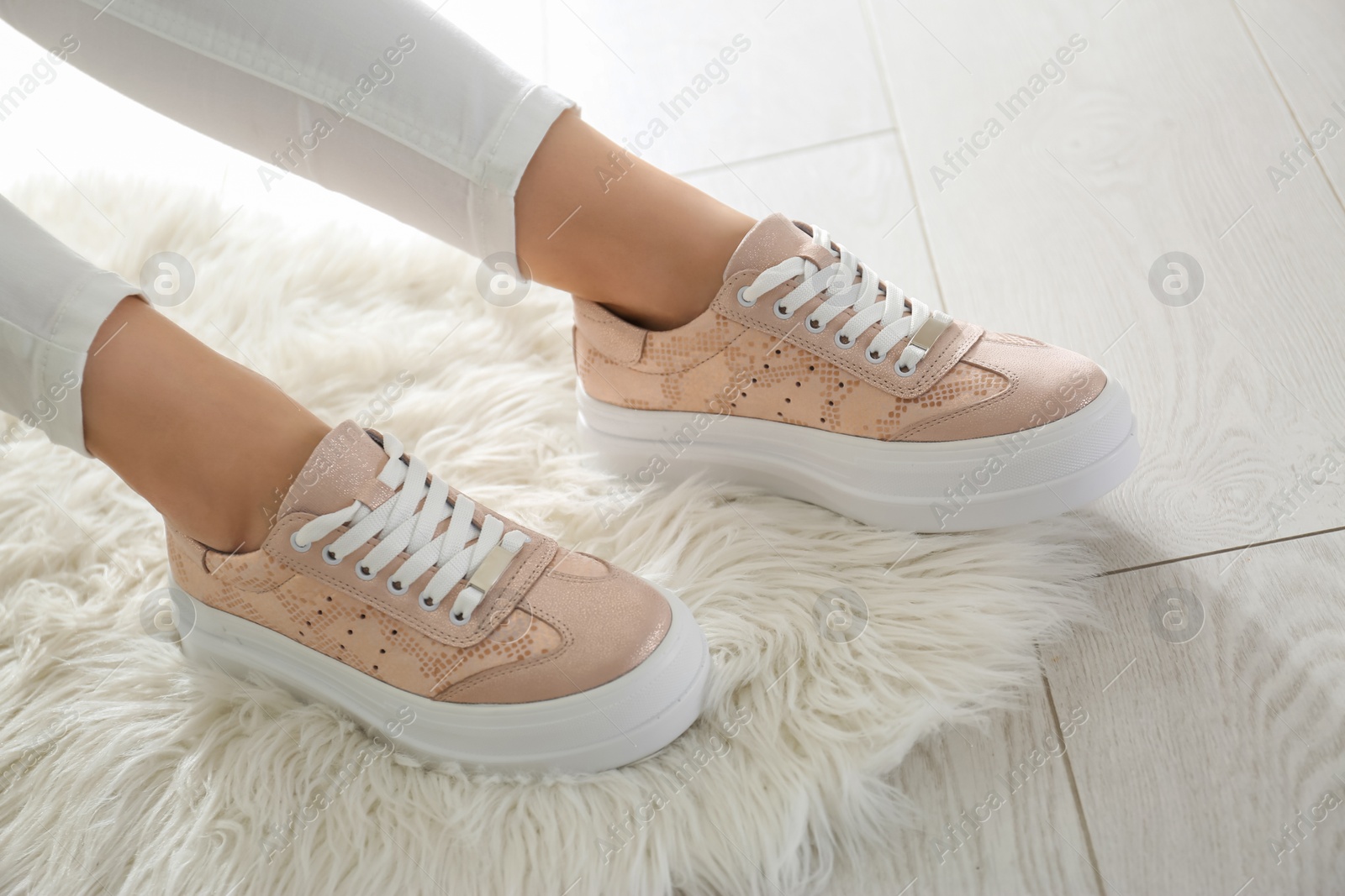 Photo of Woman wearing comfortable stylish shoes indoors, closeup