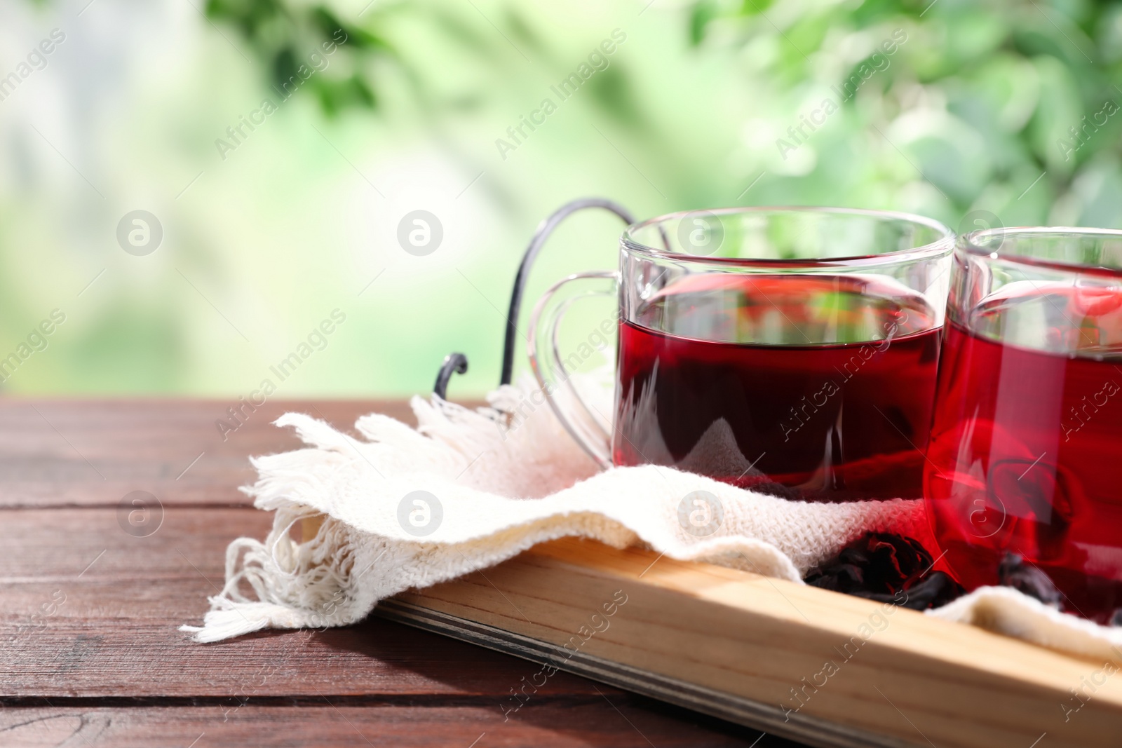 Photo of Freshly brewed hibiscus tea on wooden table