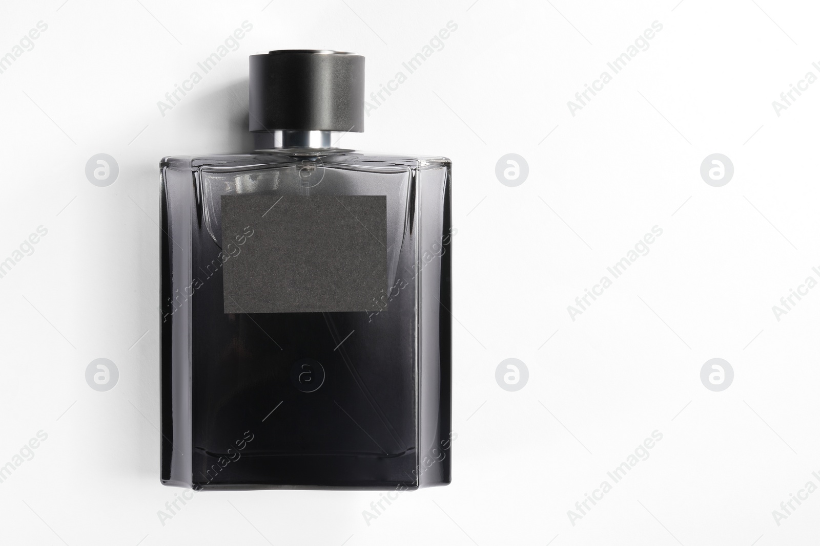 Photo of Luxury men`s perfume in bottle on white background, top view. Space for text