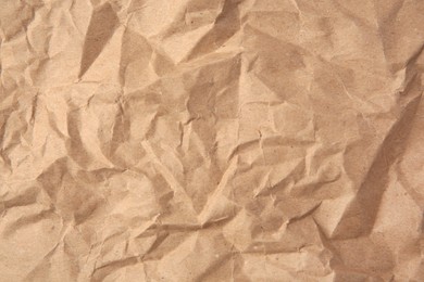 Photo of Sheet of crumpled kraft paper as background, top view