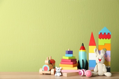 Set of different toys on wooden table. Space for text