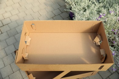 Photo of Stack of empty cardboard boxes in garden center, above view