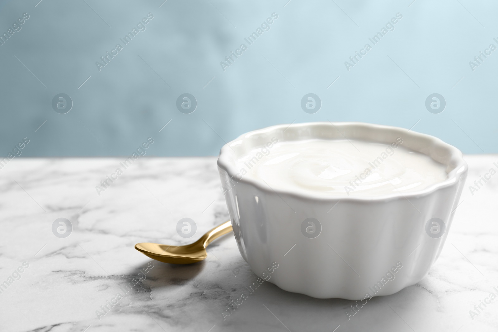 Photo of Bowl with yummy yogurt on table