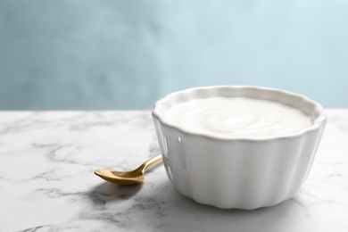 Bowl with yummy yogurt on table