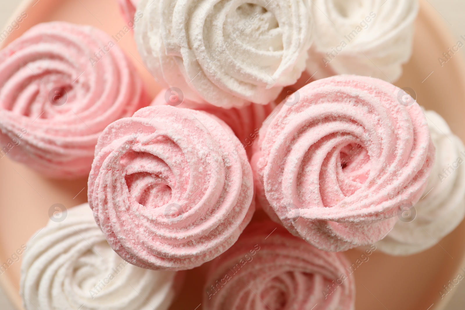 Photo of Delicious pink and white marshmallows on plate, closeup