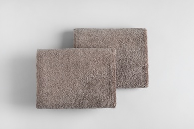 Photo of Fresh fluffy towels on grey background, top view. Mockup for design