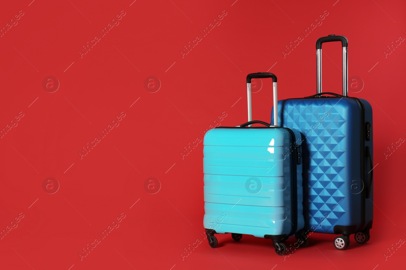 Photo of Stylish suitcases on color background. Space for text