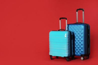 Stylish suitcases on color background. Space for text