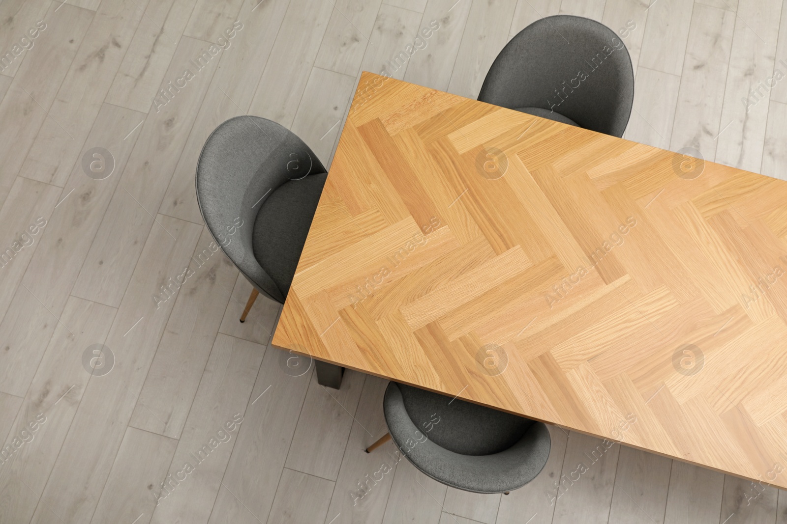 Photo of Wooden table and grey chairs indoors, top view