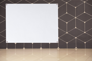 Image of Blank poster attached to wall with pattern. Space for design