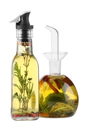 Photo of Different sorts of cooking oil with spices and herbs in bottles on white background