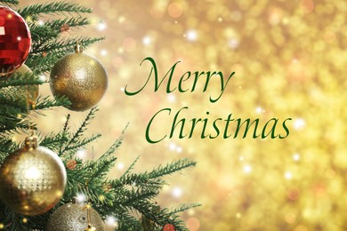 Greeting card with phrase Merry Christmas. Beautifully decorated fir tree on blurred golden background, closeup