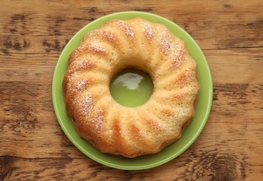 Photo of Delicious freshly baked sponge cake on wooden table, top view