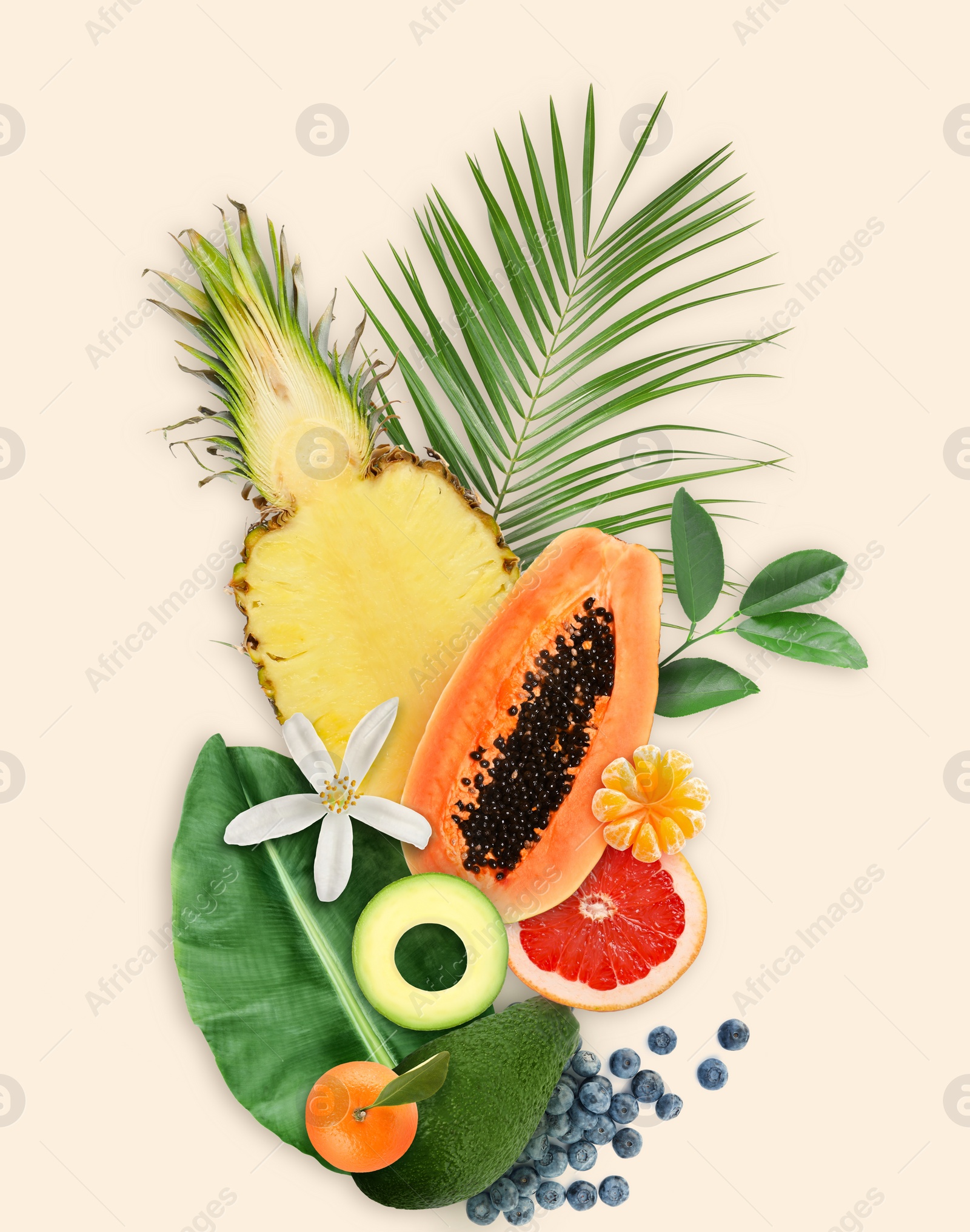 Image of Tropical layout with fresh exotic fruits and green leaves on pale beige background, top view