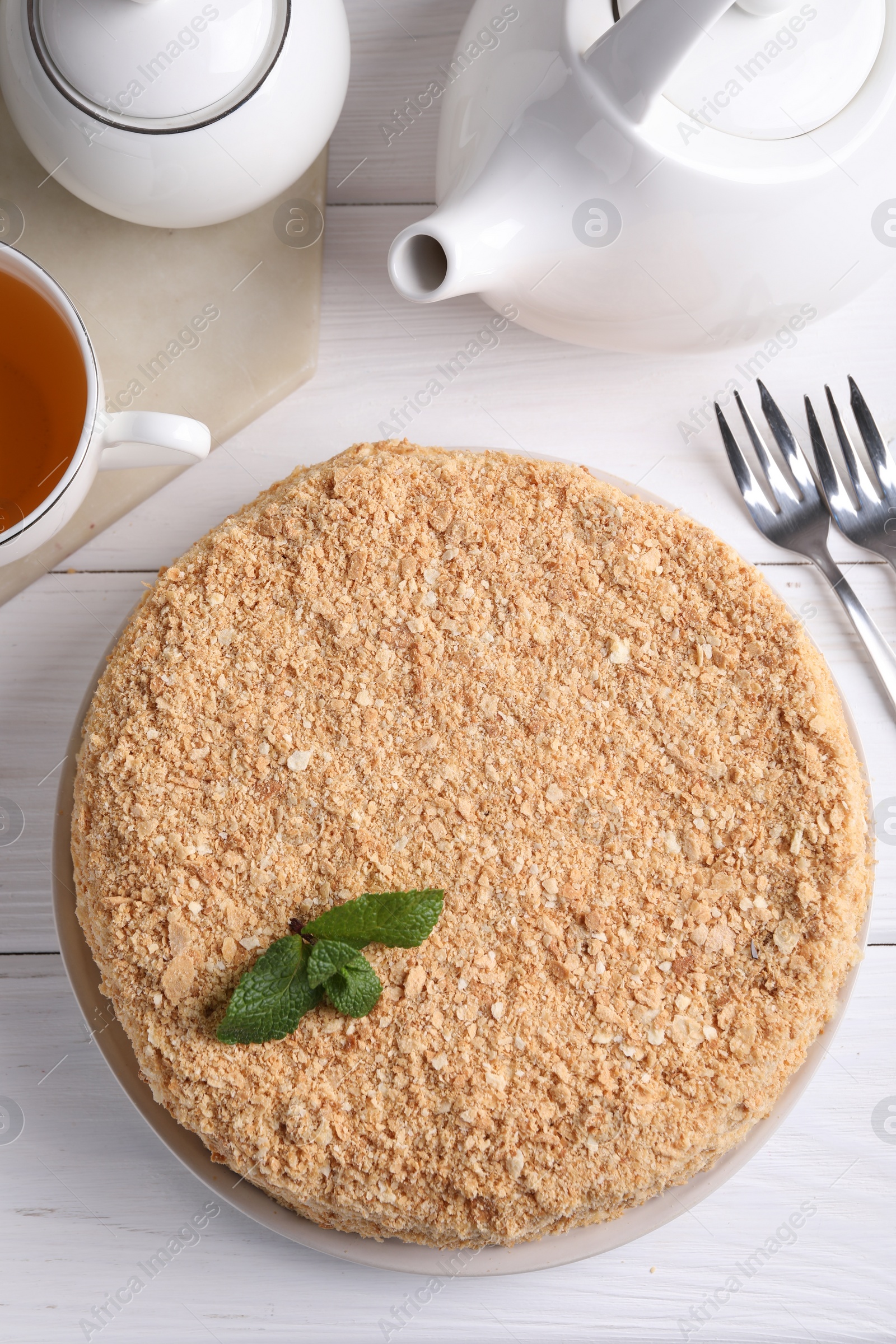 Photo of Delicious Napoleon cake served on white wooden table, flat lay