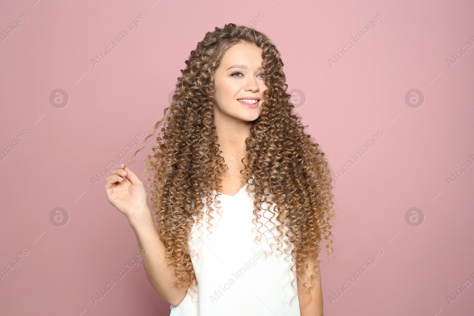 Photo of Portrait of beautiful young woman with shiny wavy hair on color background