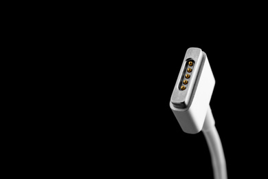 Photo of Charge cable on black background, closeup. Space for text