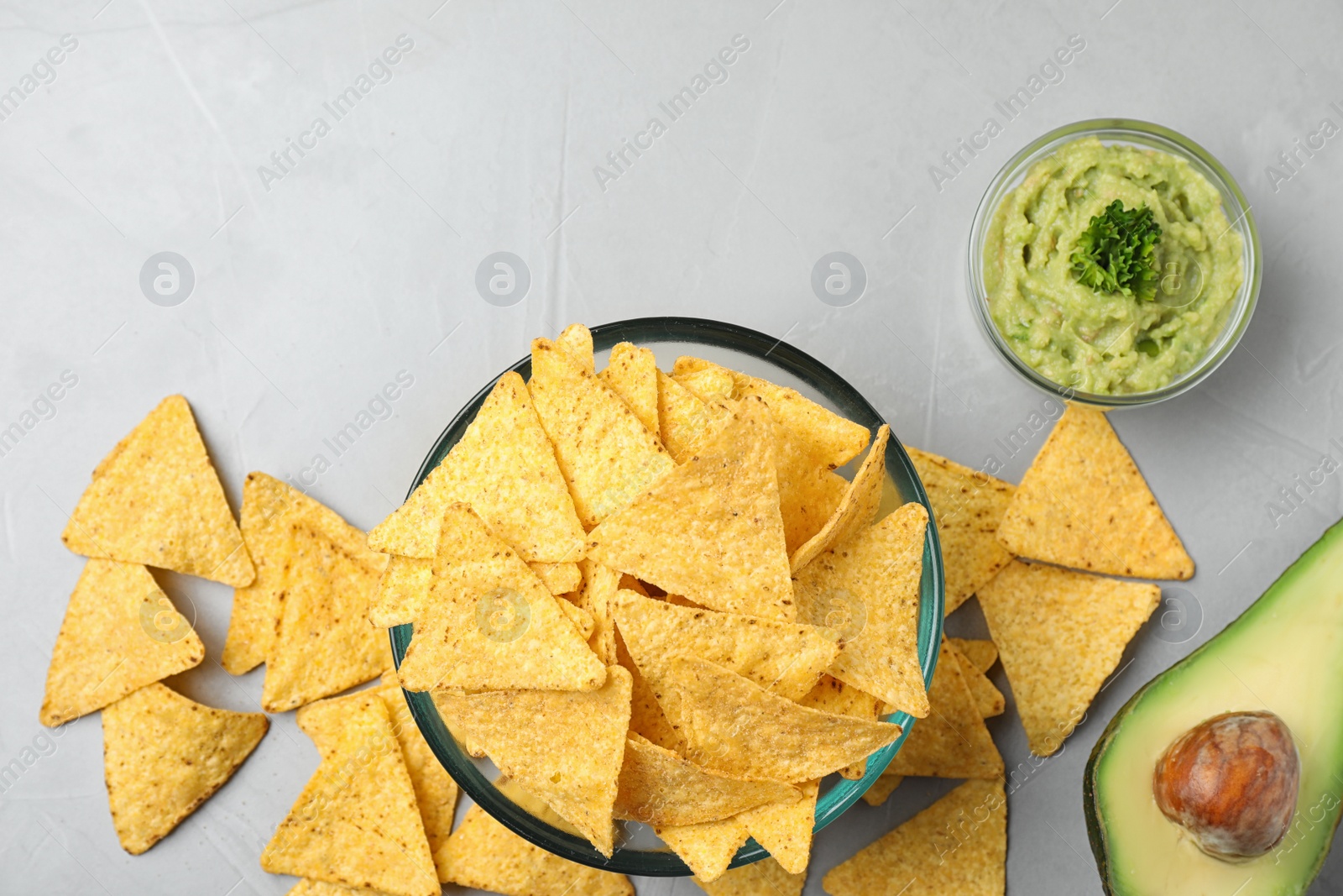 Photo of Flat lay composition with tasty Mexican nachos chips on grey table, space for text