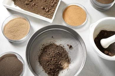 Photo of Laboratory equipment for pulverizing and sieving of soil samples on light table, flat lay