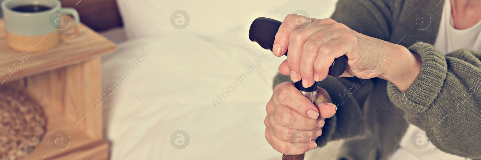 Image of Elderly woman with walking cane indoors, closeup. Banner design