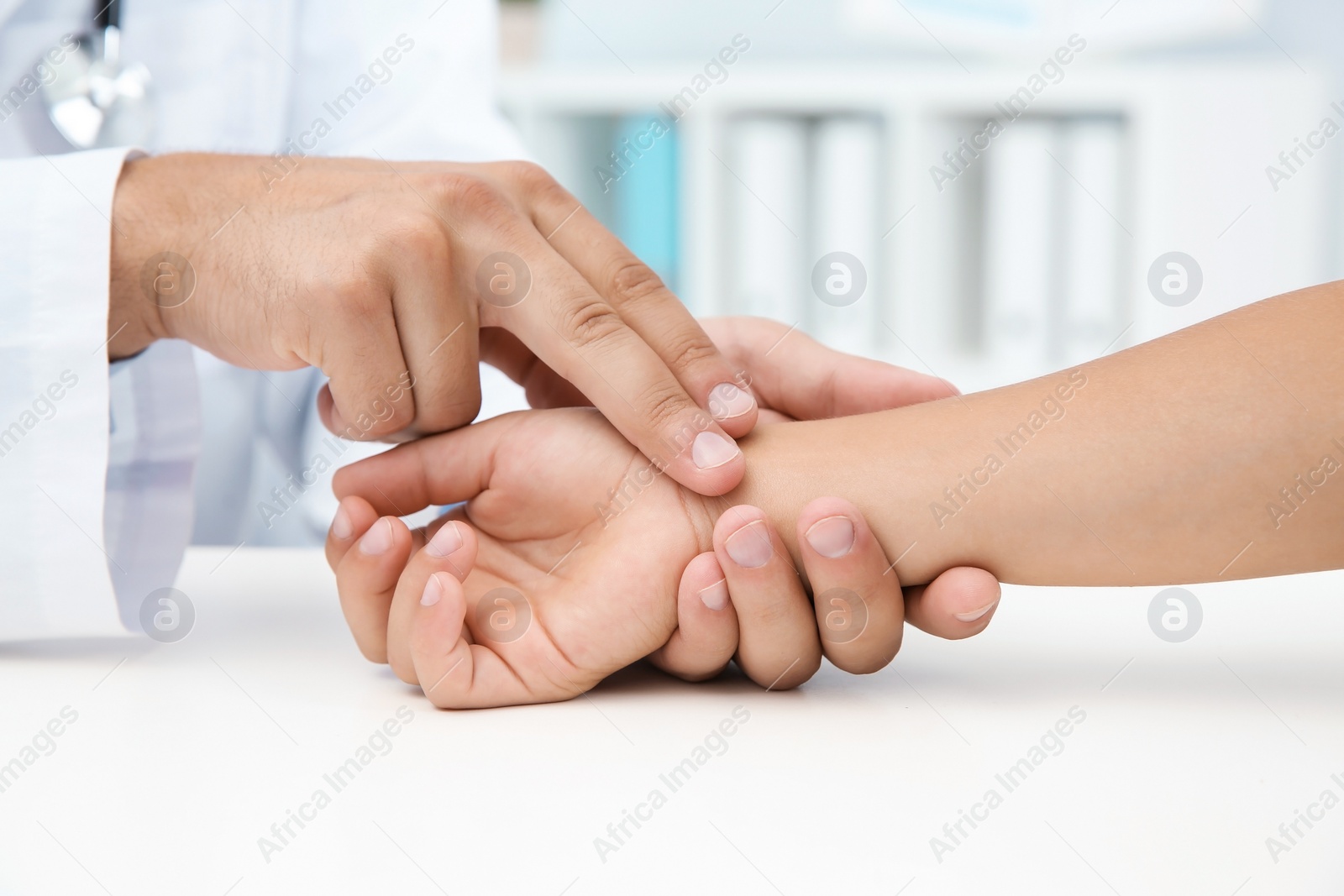 Photo of Doctor checking little boy's pulse in hospital