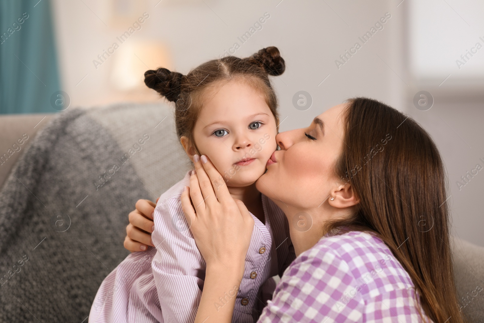 Photo of Young mother with little daughter at home