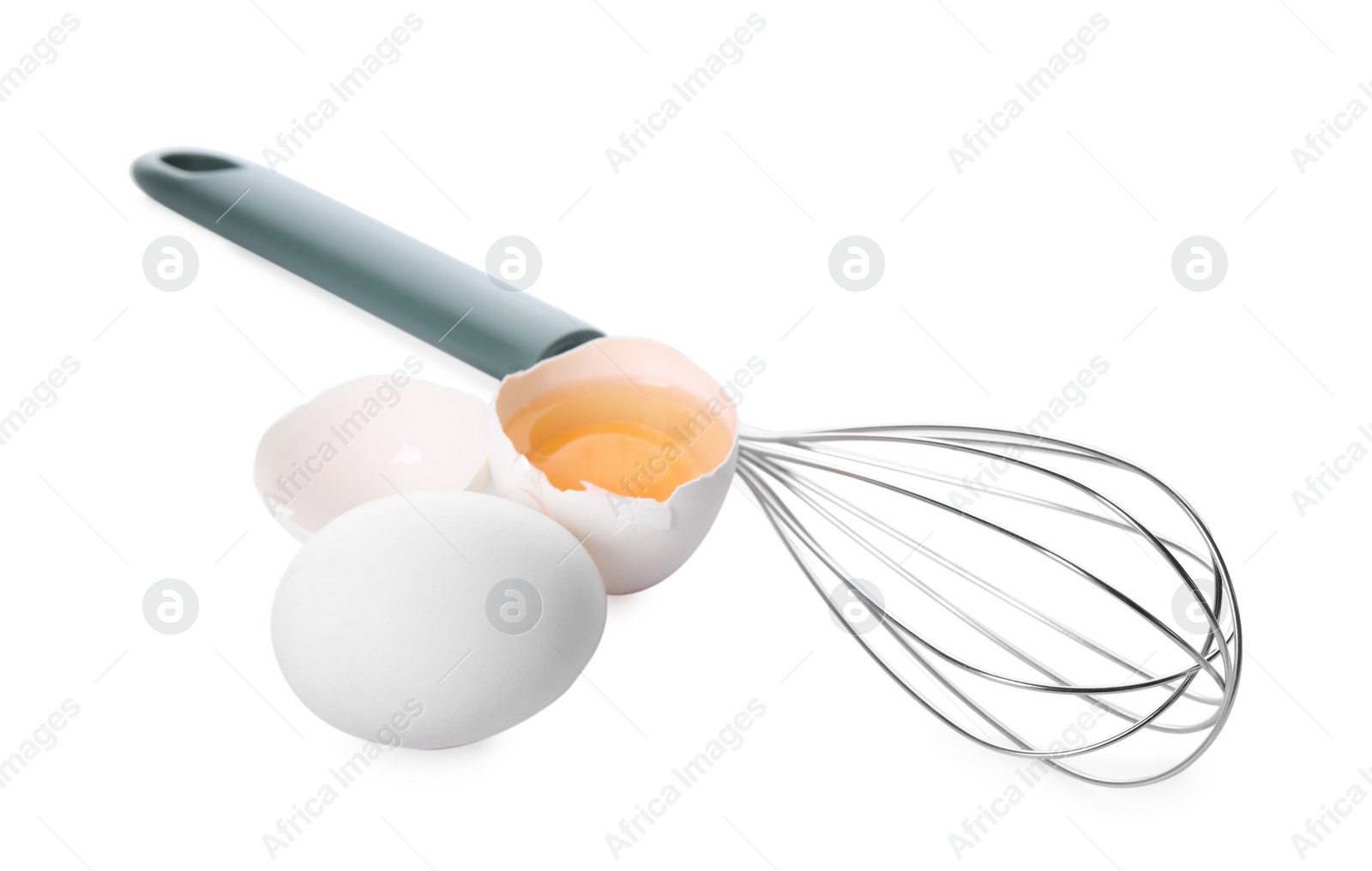 Photo of Whisk, whole and broken eggs isolated on white