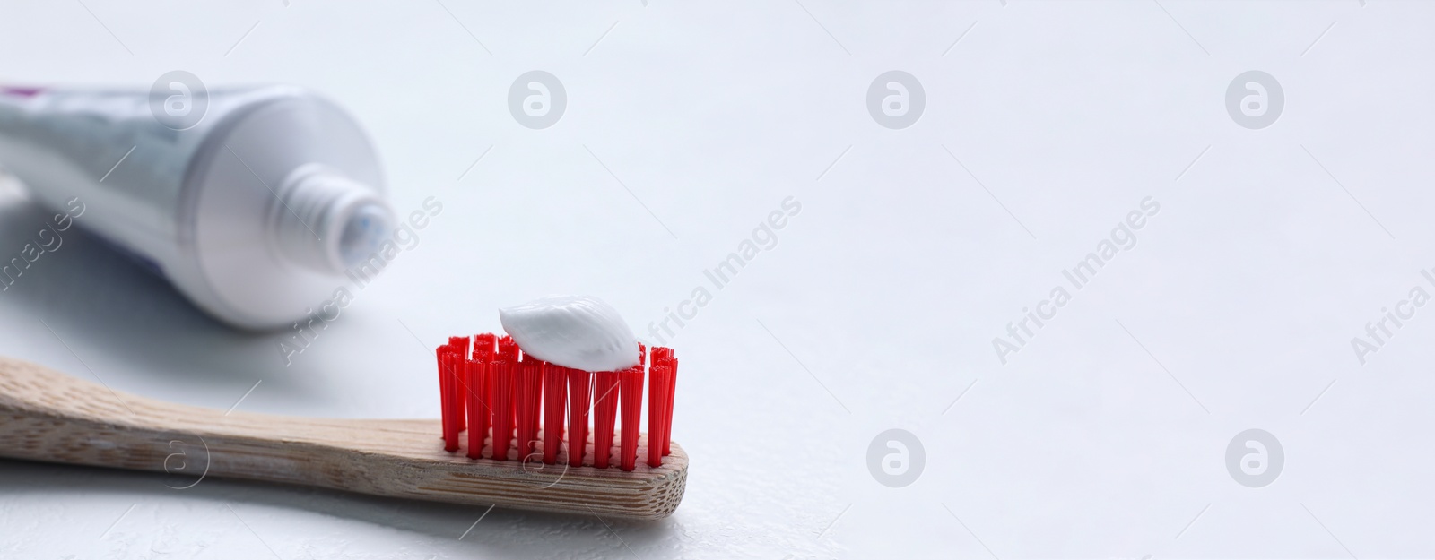 Image of Tube and brush with toothpaste on white background, space for text. Banner design