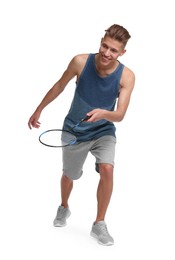 Young man playing badminton with racket on white background