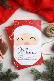 Photo of Flat lay composition with Christmas cards on white wooden background