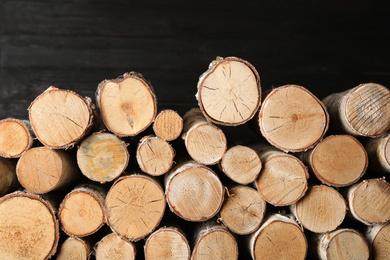 Cut firewood on black background. Heating in winter