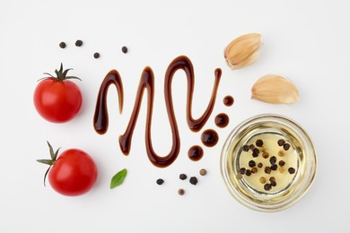 Organic balsamic vinegar and cooking ingredients on white background, flat lay