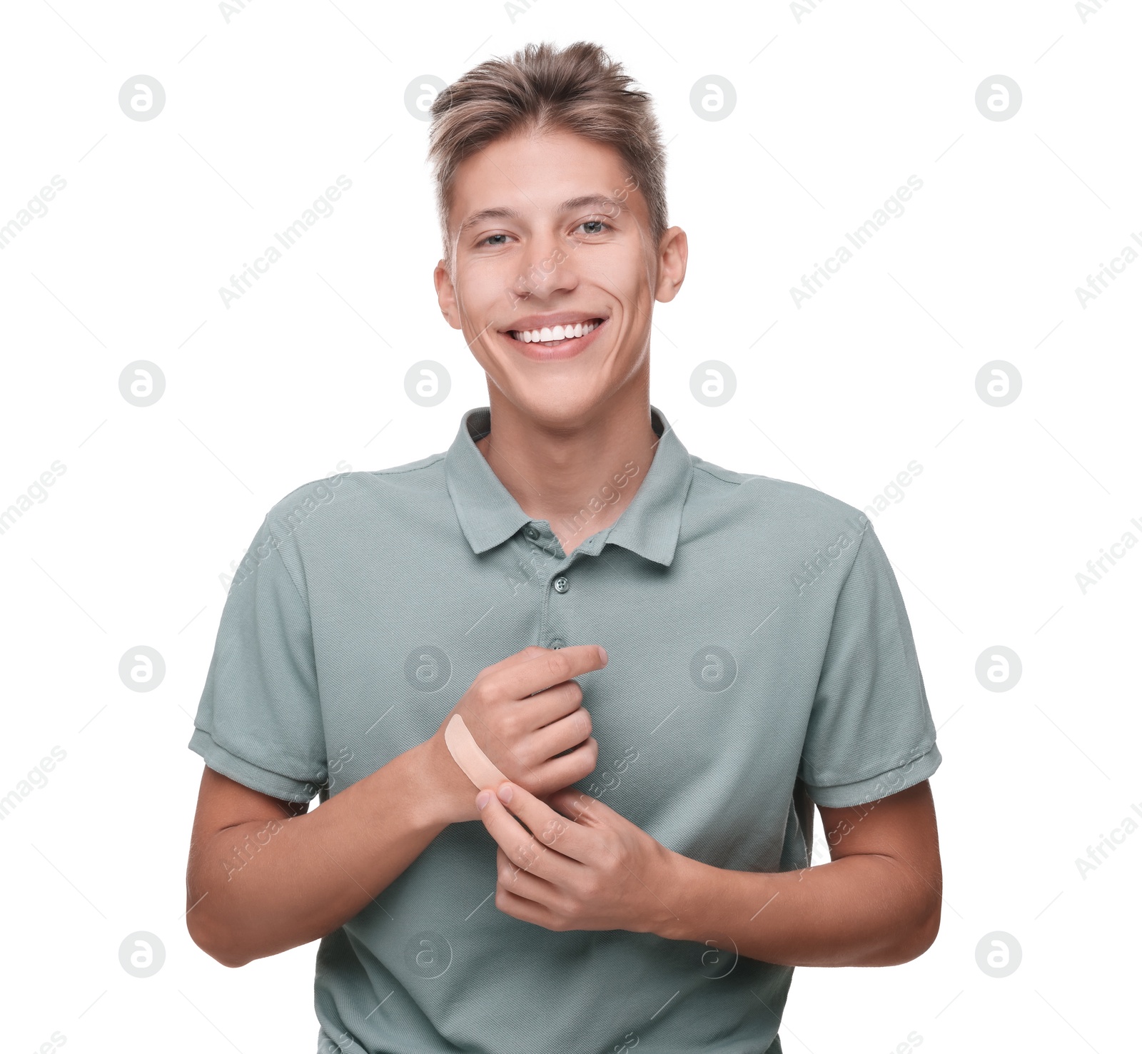 Photo of Handsome man putting sticking plaster onto hand on white background