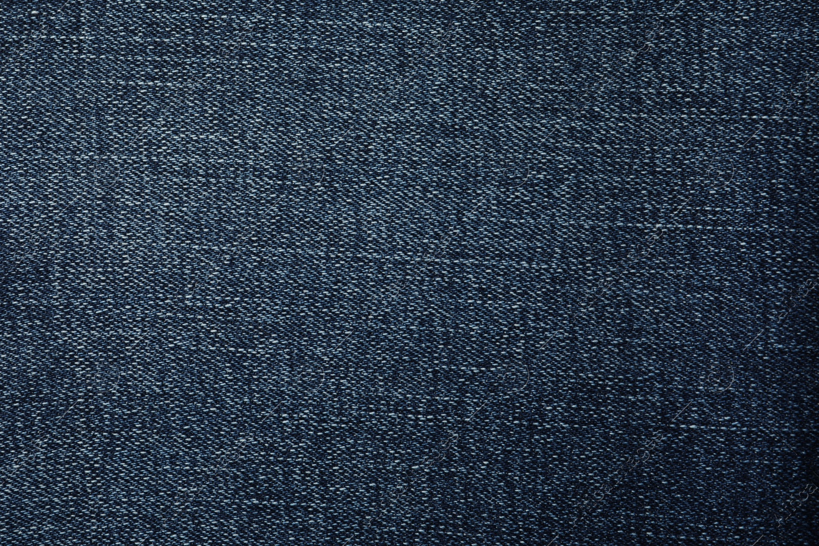 Photo of Texture of dark blue jeans as background, closeup