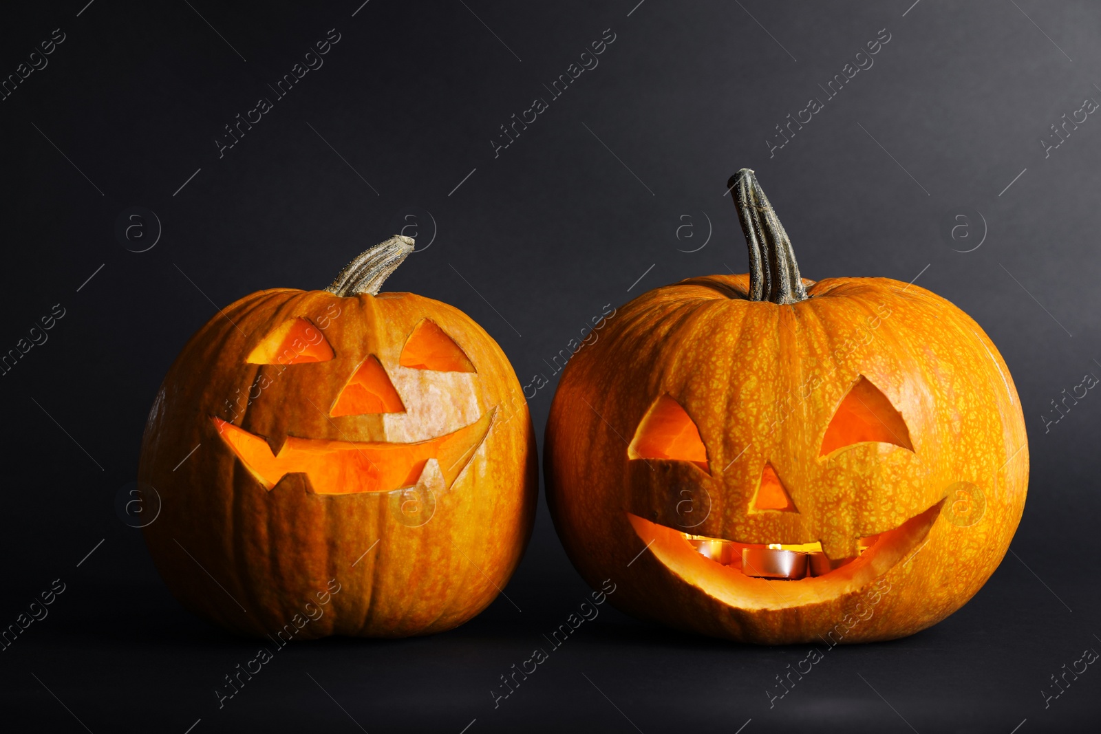 Photo of Halloween pumpkin head jack lanterns on dark background