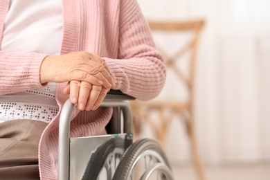 Photo of Handicapped elderly woman in nursing home, closeup with space for text. Assisting senior generation