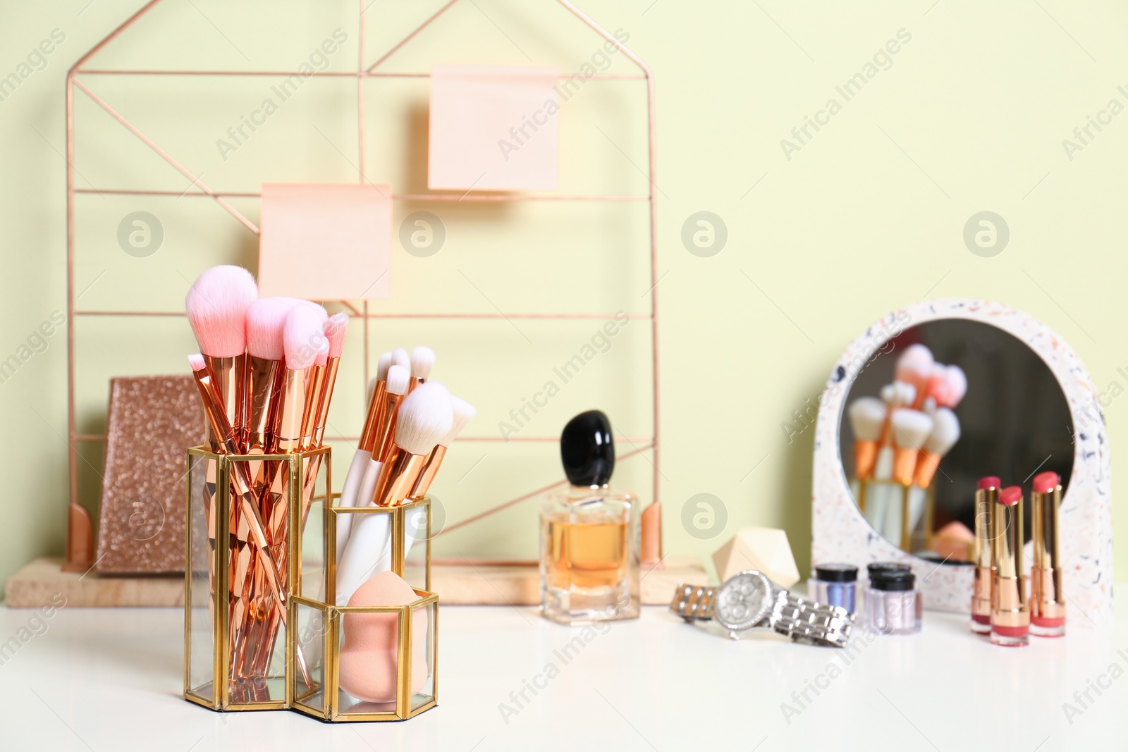 Photo of Set of makeup products and brushes on table. Space for text