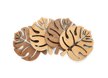 Photo of Leaf shaped wooden cup coasters on white background, top view
